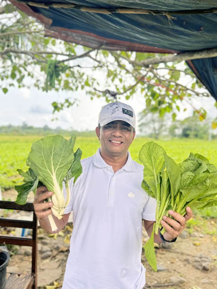 Si Noel Tolentino na may mga halaman sa kanyang bukid